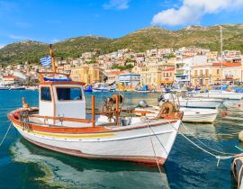 Lais Puzzle - Traditionelles griechisches Boot im Hafen von Samos mit bunten Häusern im Hintergrund, Griechenland - 40, 100, 200, 500, 1.000 & 2.000 Teile