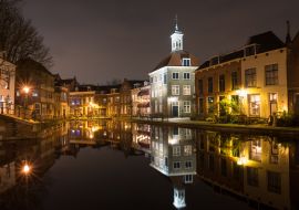 Lais Puzzle - Aussicht auf Gebäude entlang einer Gracht in der historischen Stadt Schiedam, Niederlande. Das hohe Gebäude mit der Turmspitze ist als "The Porters' Guild House" bekannt. - 1.000 Teile