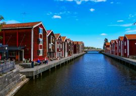 Lais Puzzle - Hudiksvall, Schweden Menschen, die zwischen alten Fischerbooten am Sundskanalen, auch Moljen genannt, sitzen - 1.000 Teile