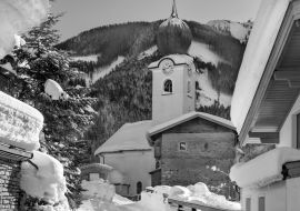 Lais Puzzle - Alte Kirche über verschneiten Bergen in Saalbach - Hinterglemm, Österreich in schwarz weiß - 1.000 Teile