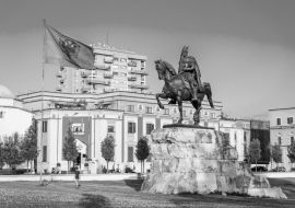 Lais Puzzle - Skanderbeg-Platz mit Fahne, Skanderbeg-Denkmal und die Et'hem Bey Moschee im Zentrum von Tirana, Albanien in schwarz weiß - 1.000 Teile