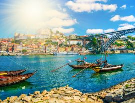 Lais Puzzle - Brücke Dom Luis I. und traditionelle Boote auf dem Fluss Rio Douro in Porto, Portugal - 1.000 Teile